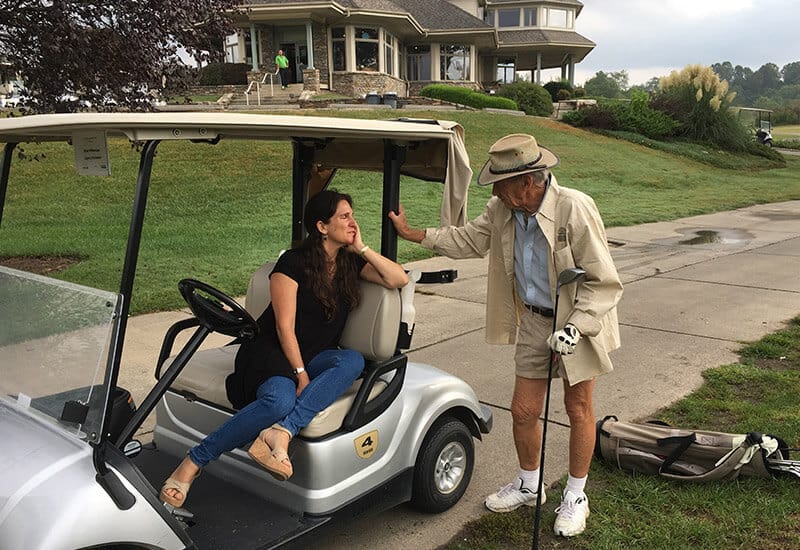 Golfer chatting with woman